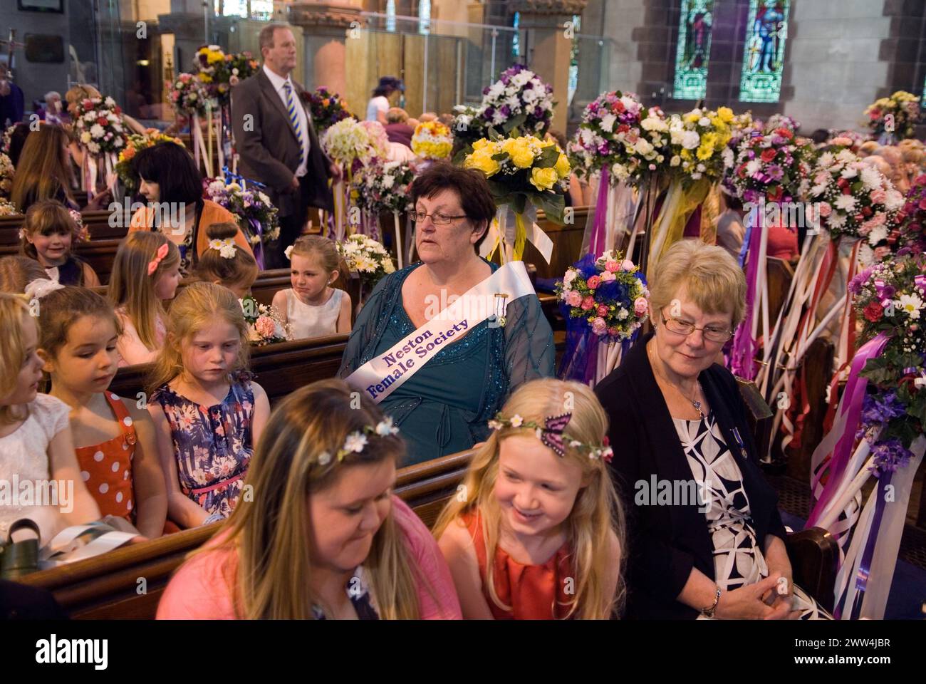 Children gather in Neston village church for a service of thanks giving. Neston Female Friendly Society (now called Ladies Club), Annual Club Walking Day. Neston Cheshire UK 2015. 2010s UK HOMER SYKES. Stock Photo