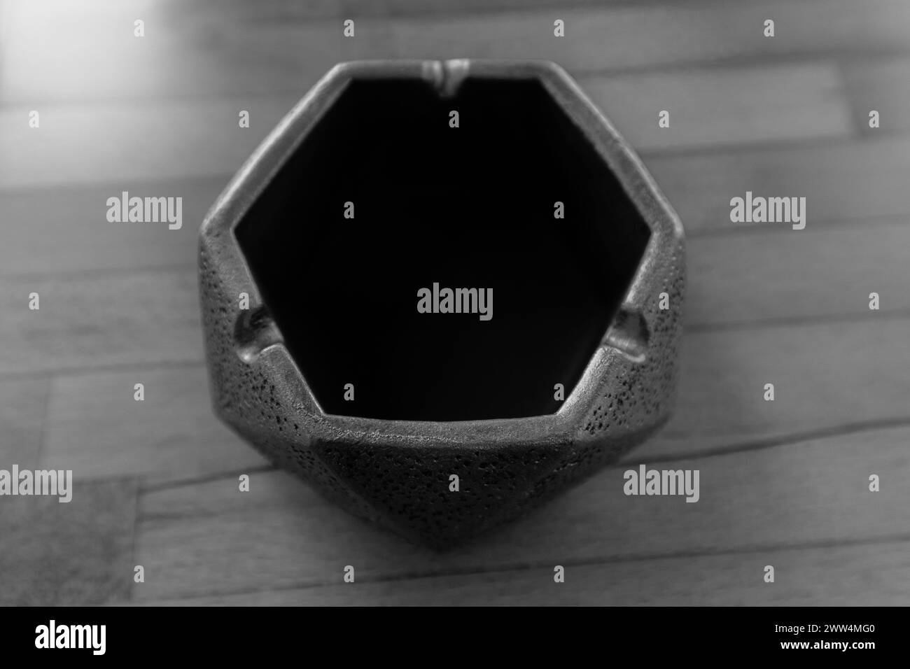 Monochrome , edge hexagon shape, empty black ashtray. Minimalist, table decoration. Stock Photo