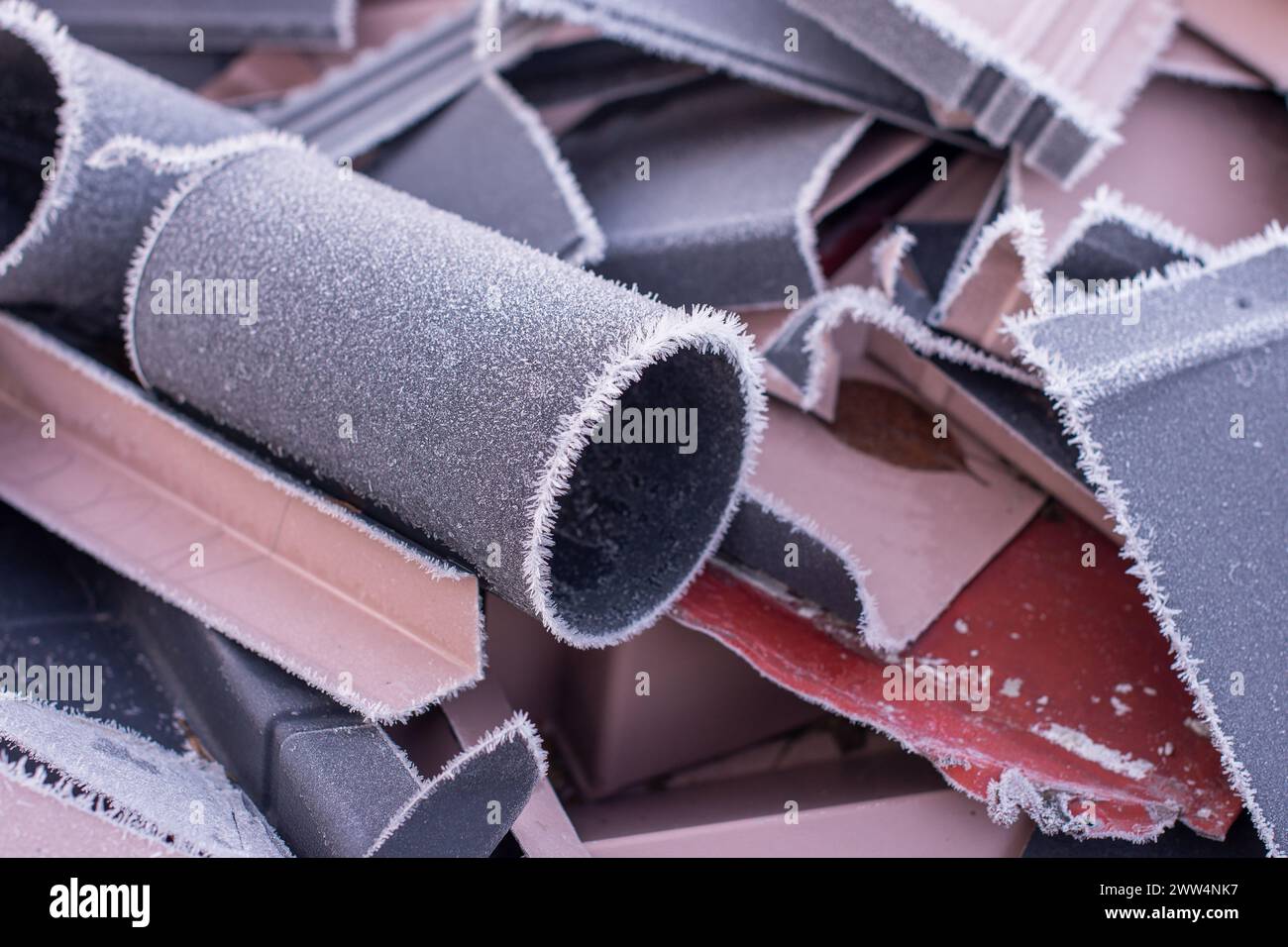 A piece of metal pipe covered in small crystals of frost Stock Photo