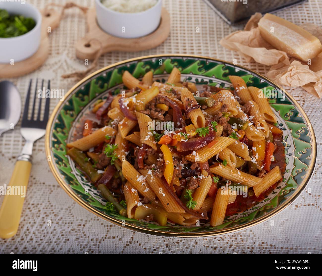 Pasta bolognese garnished with herbs and grated cheese. Stock Photo