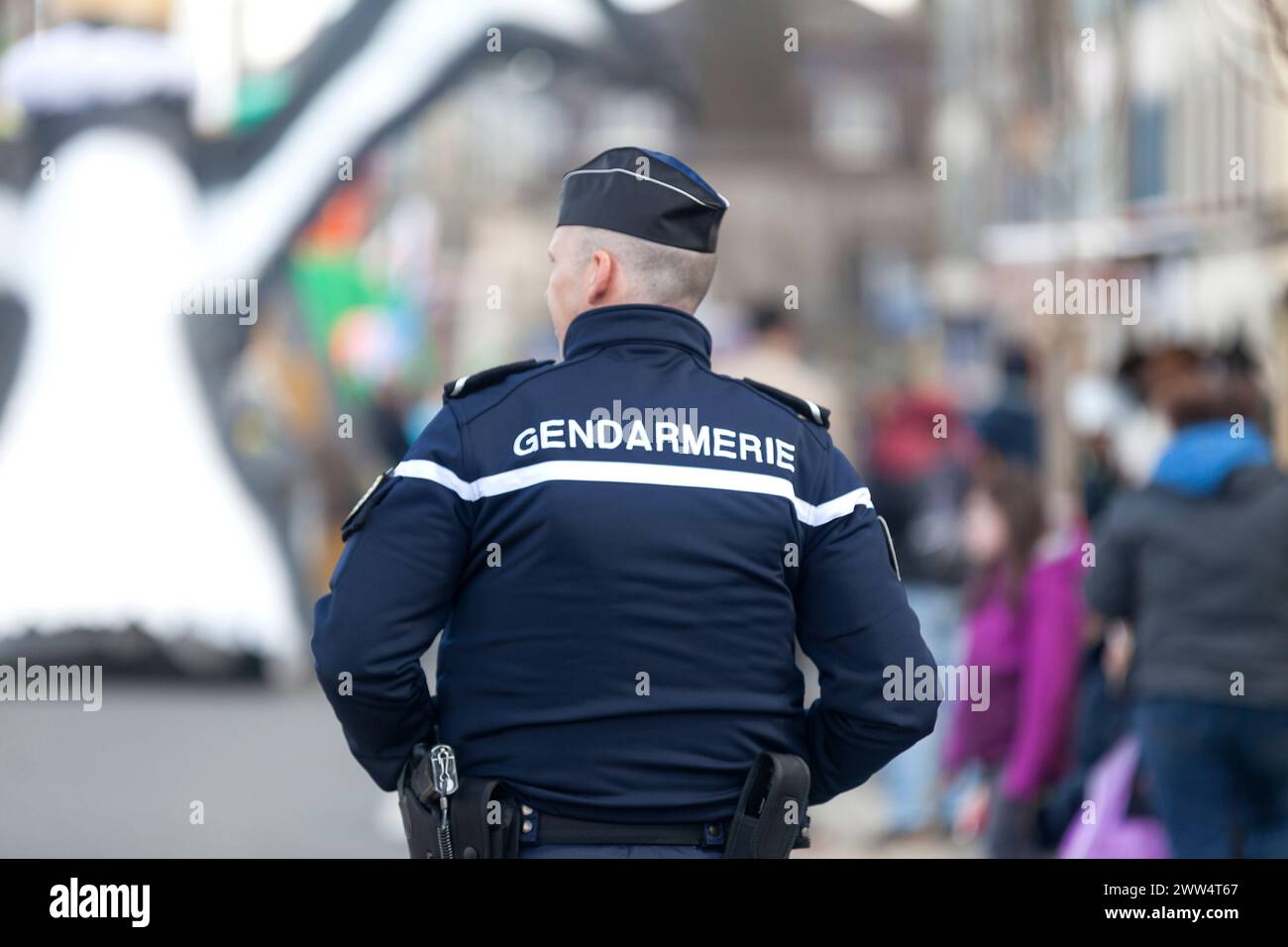 Landerneau, France - April 03 2022: Gendarme monitoring the crowd during the carnival of Landerneau. Stock Photo