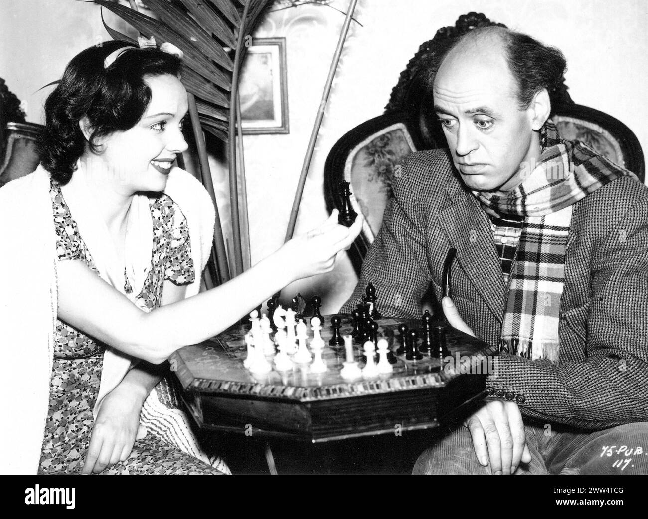 British Actress JESSIE MATTHEWS and  comic actor ALASTAIR SIM playing chess between scenes during the making of CLIMBING HIGH 1938 Director CAROL REED Dresses by NORMAN HARTNELL Gaumont British Stock Photo