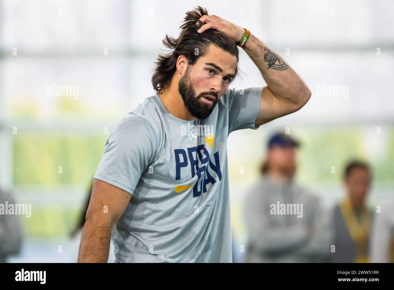 Notre Dame quarterback Sam Hartman fixes his hair between drills during