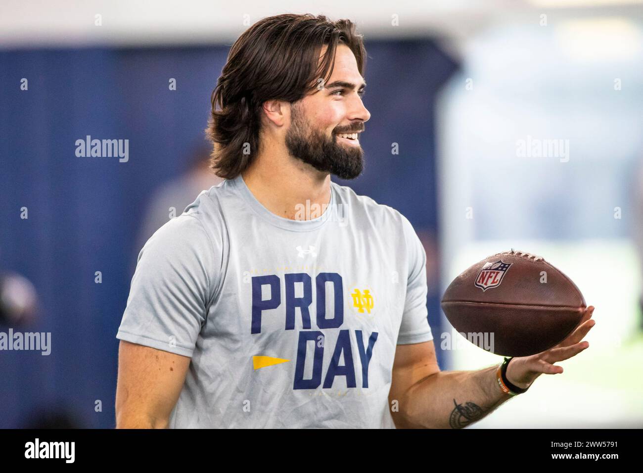 Notre Dame quarterback Sam Hartman spins an NFL branded football while