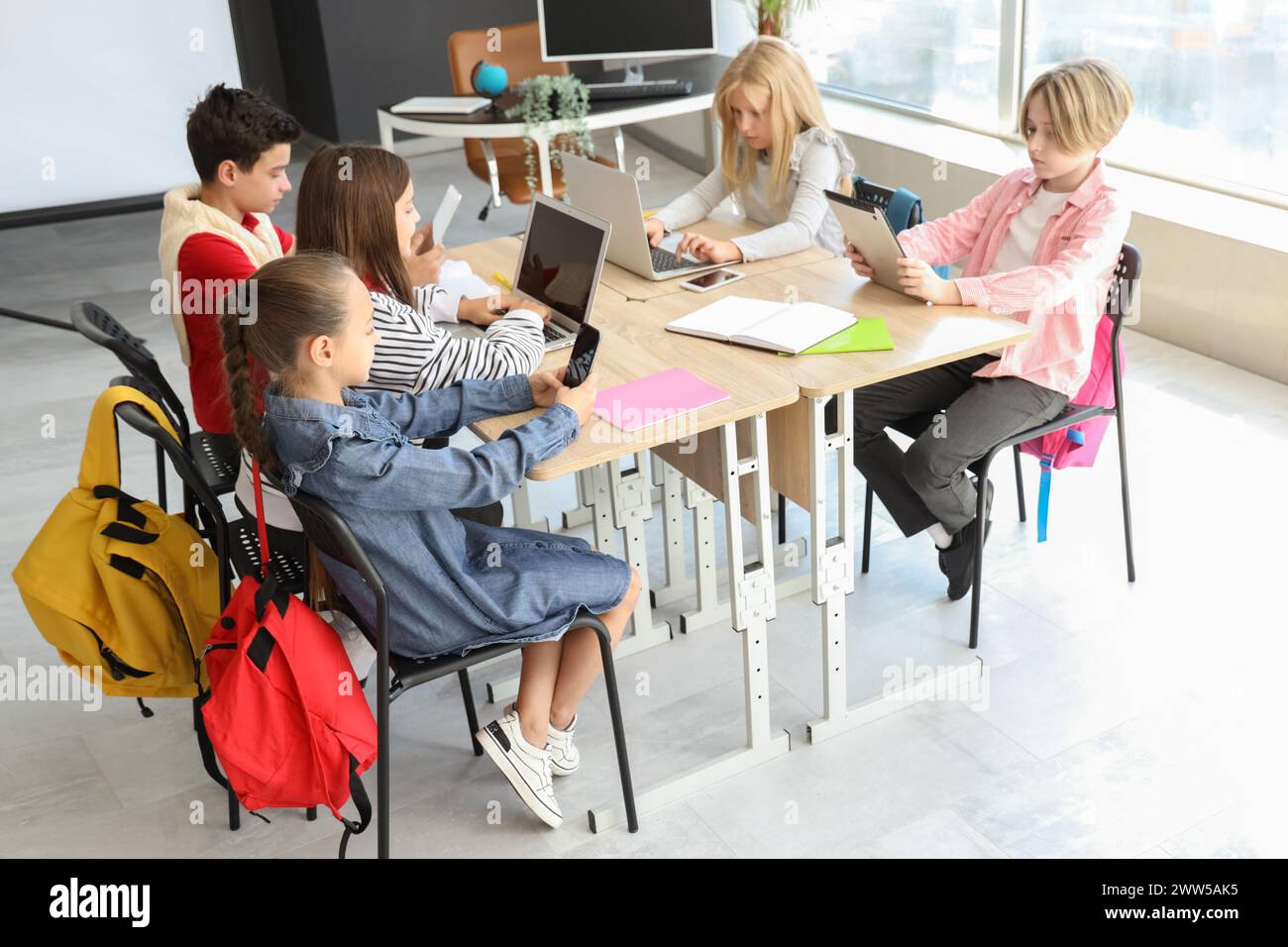 Little children studying with devices at school computer lab Stock ...
