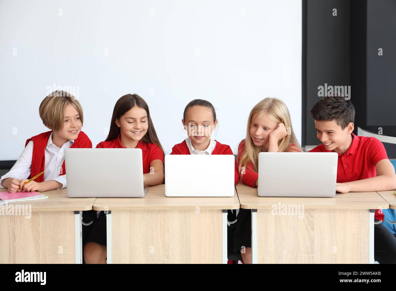 Little children studying with laptops at school computer lab Stock ...