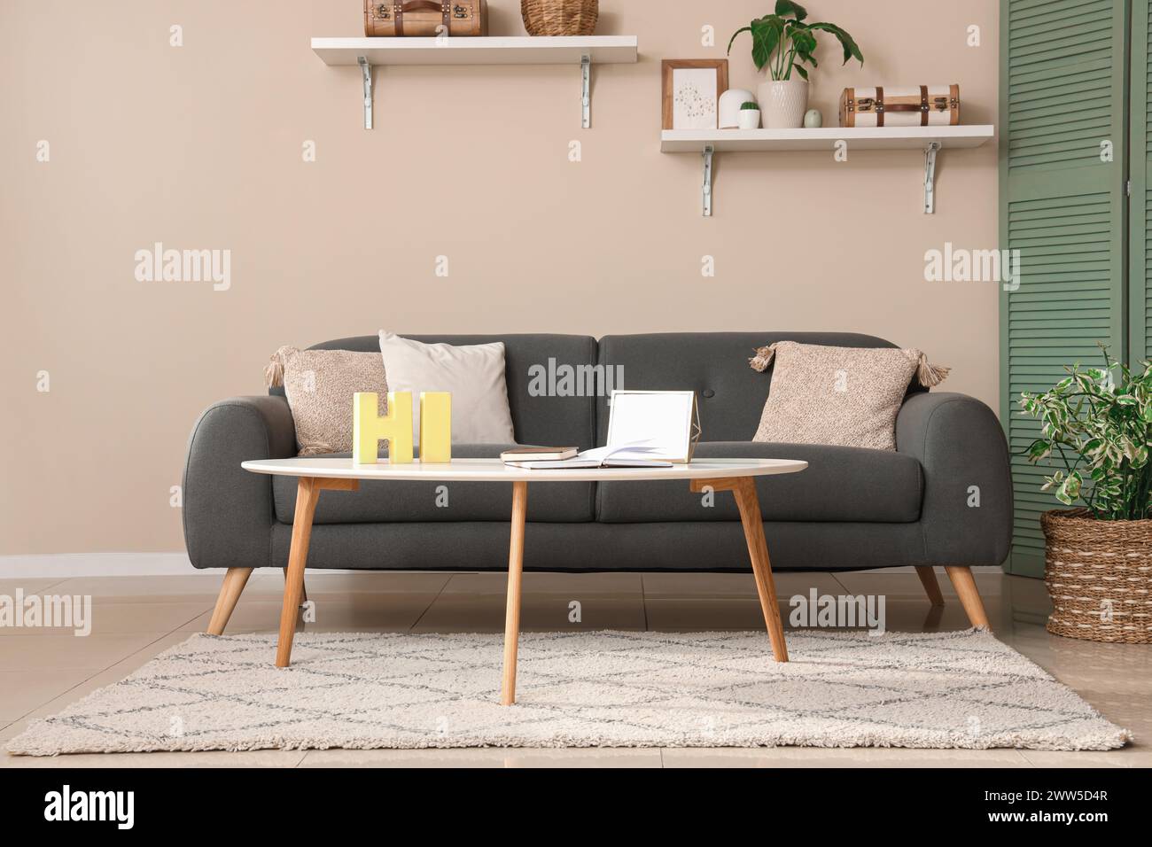 Modern interior of comfortable living room with black sofa, table and ...