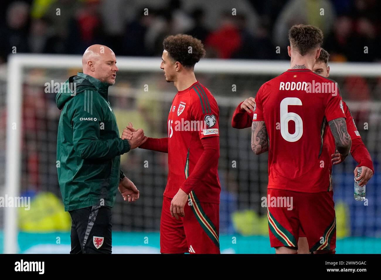Ehhan Wales' head coach Rob Page, left, shakes hands with Wales' Ehhan Ampadu ...