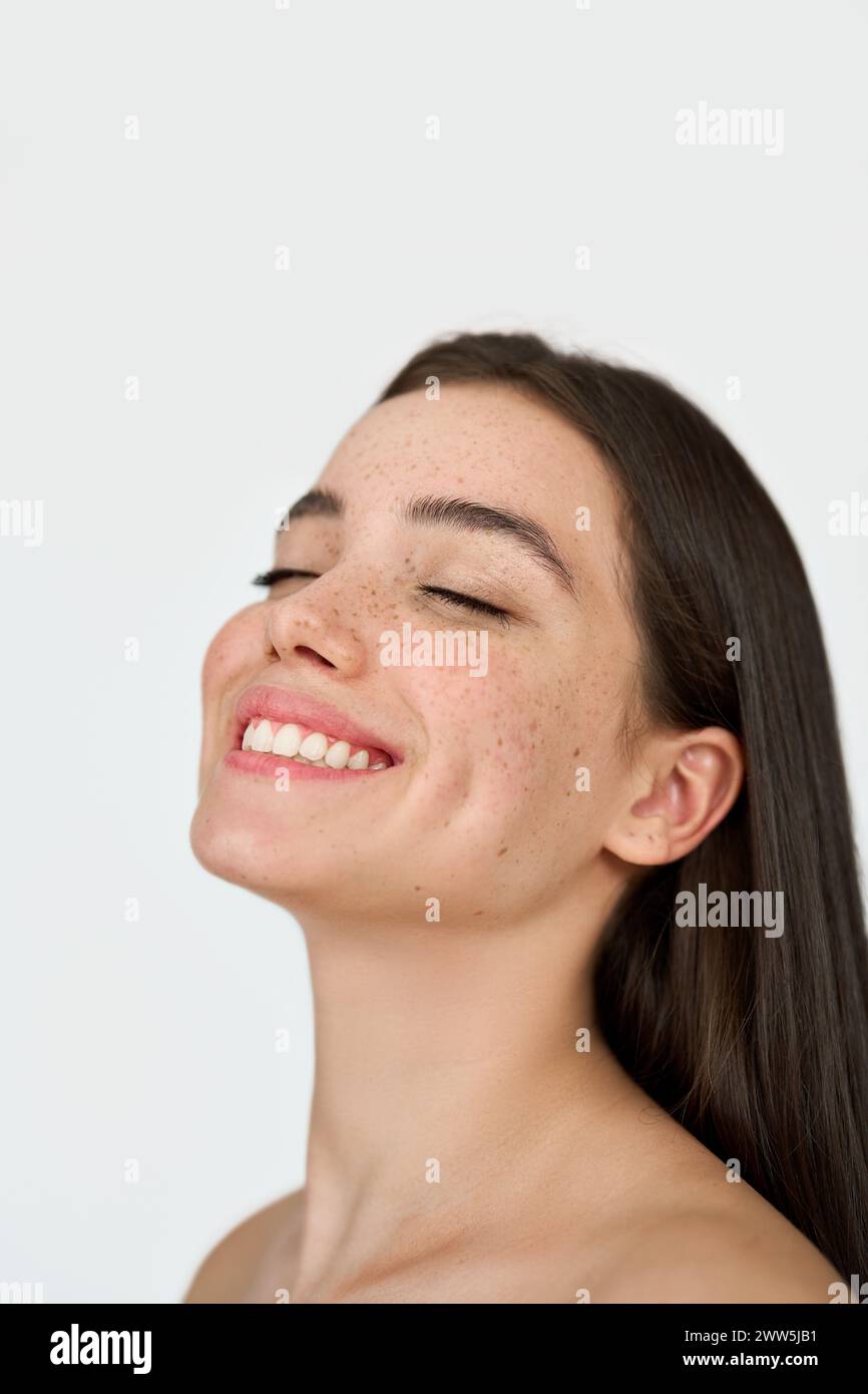 Happy brunette Latin girl with freckles on face isolated on white background. Stock Photo