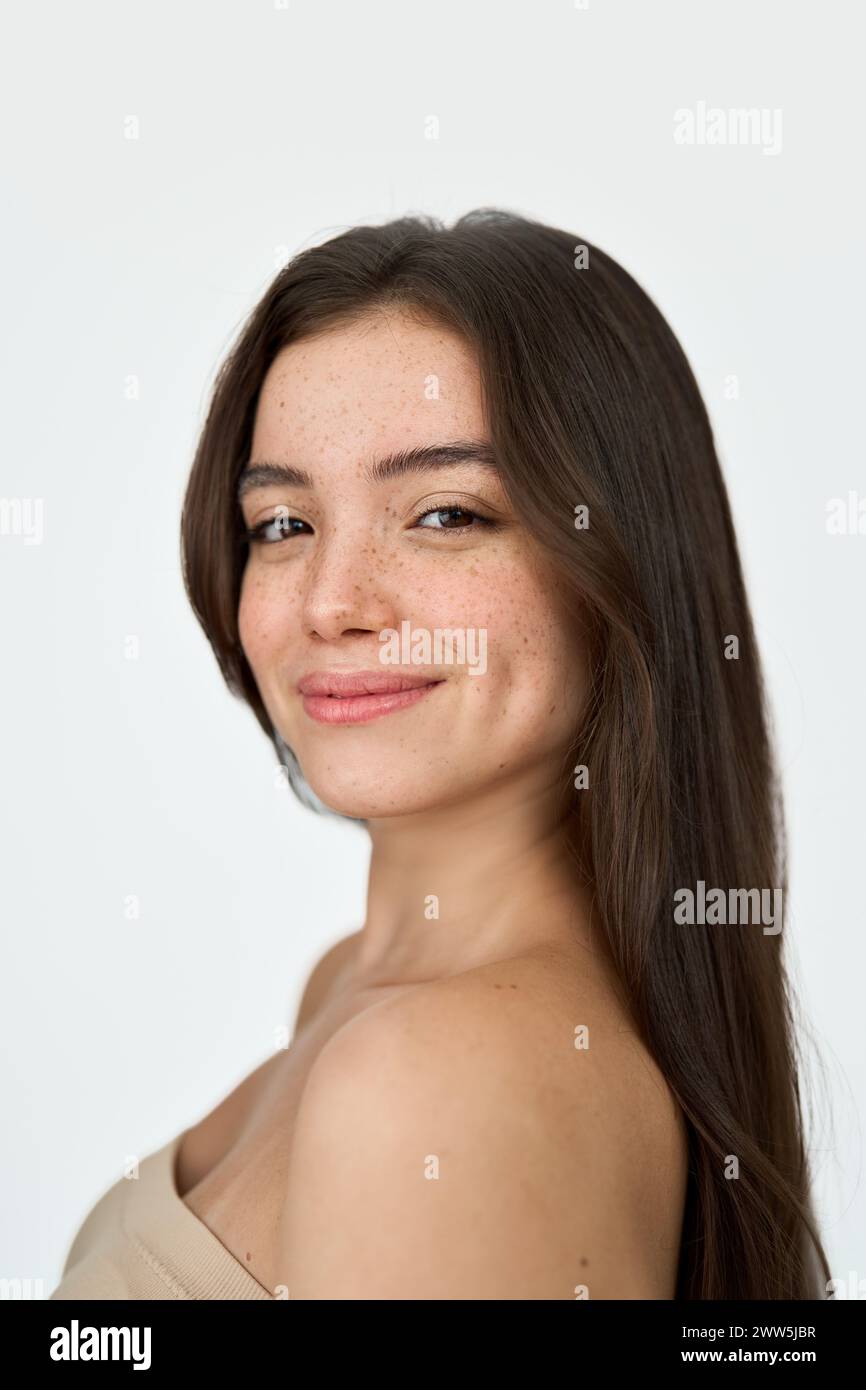 Happy brunette girl with freckles on face, isolated on white, vertical portrait. Stock Photo