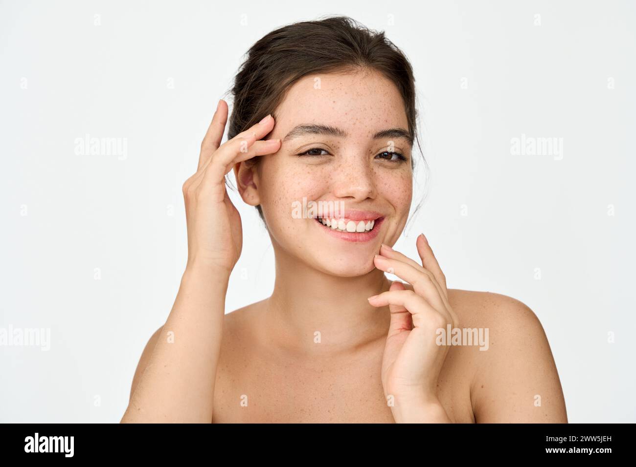 Beauty portrait of happy Latin girl advertising cosmetic for skin care. Stock Photo