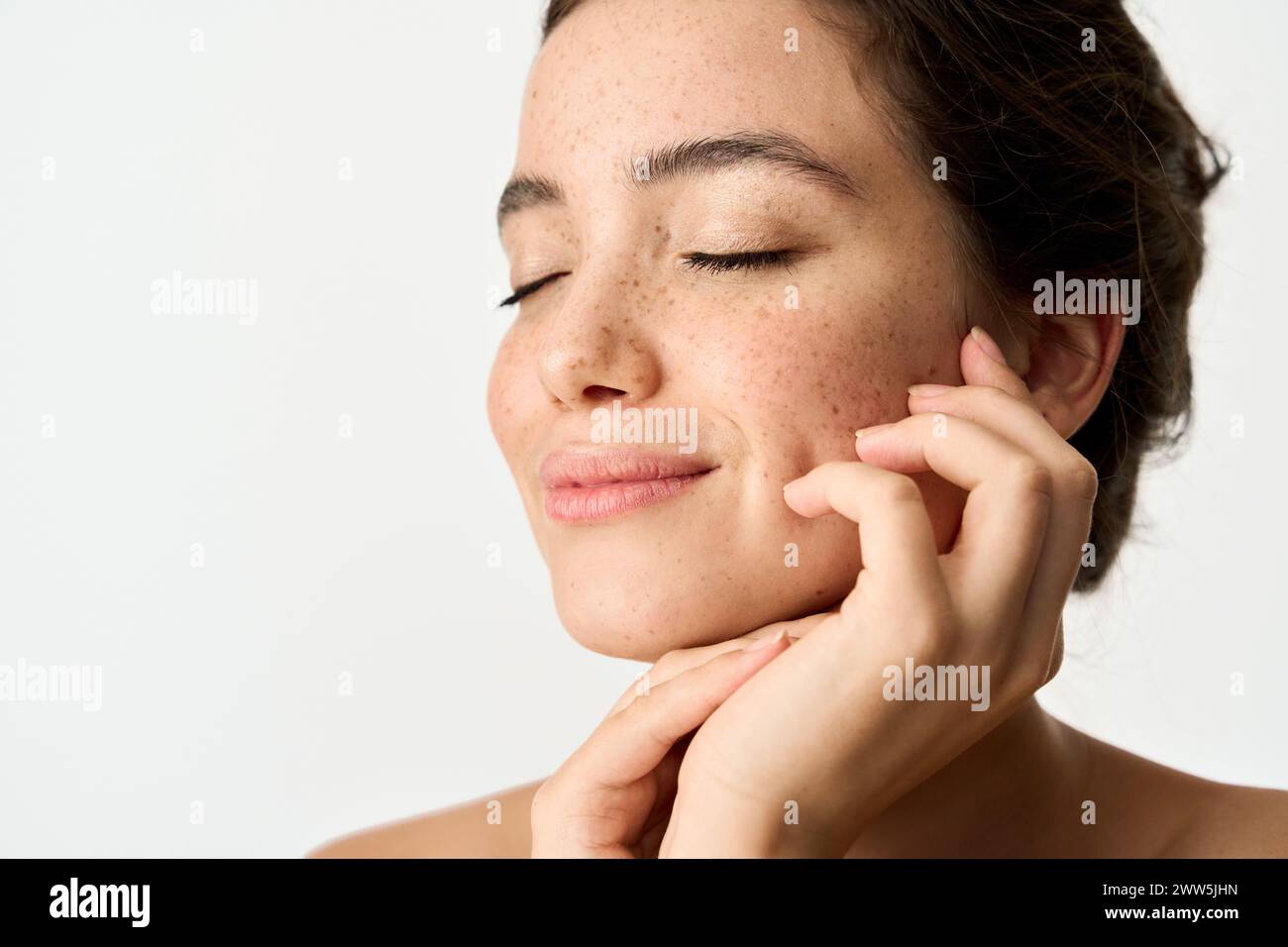 Beauty photo of smiling young woman with freckles on face isolate on white. Stock Photo