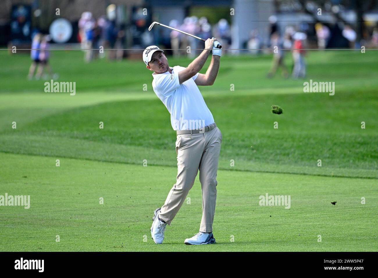 Russell Henley watches after hitting from the first fairway during the