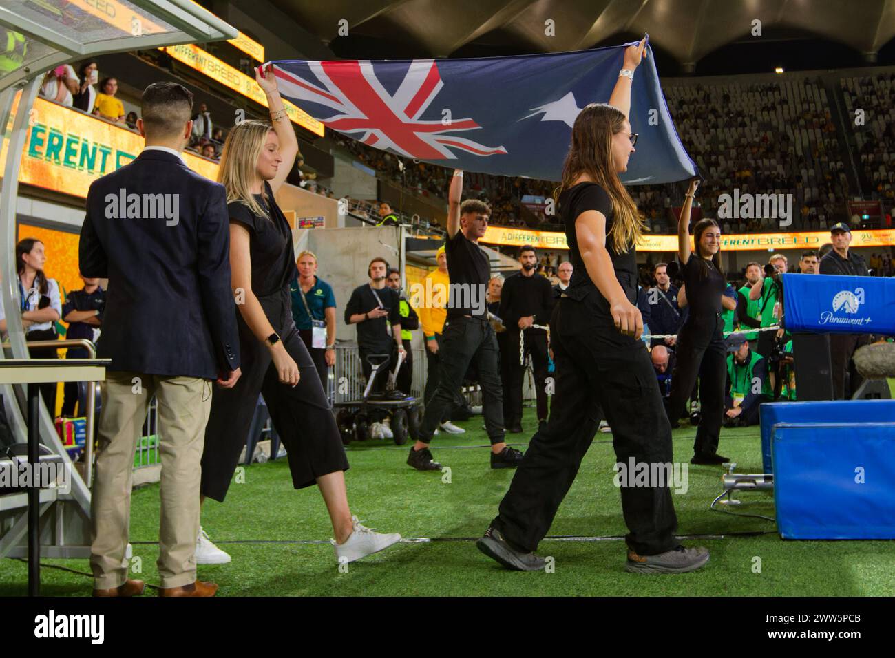 Sydney, Australia. 21st Mar, 2024. The Australian Flag enters the pitch before the FIFA World Cup 2026 Qualifier match between Australia and Lebanon at Western Sydney Stadium on March 21, 2024 in Sydney, Australia Credit: IOIO IMAGES/Alamy Live News Stock Photo