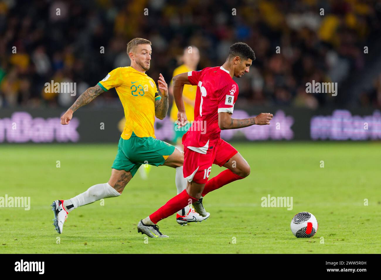 Sydney, Australia. 21st Mar, 2024. Adam Taggart of Australia competes for the ball with Walid Shour of Lebanon during the FIFA World Cup 2026 Qualifier match between Australia and Lebanon at Western Sydney Stadium on March 21, 2024 in Sydney, Australia Credit: IOIO IMAGES/Alamy Live News Stock Photo