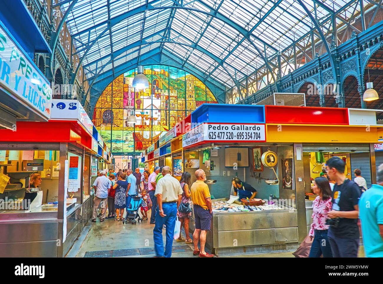 MALAGA, SPAIN - SEPT 28, 2019: People walk in fish section of Atarazanas central market, choosing fresh fish and seafood on ice, on Sept 28 in Malaga Stock Photo