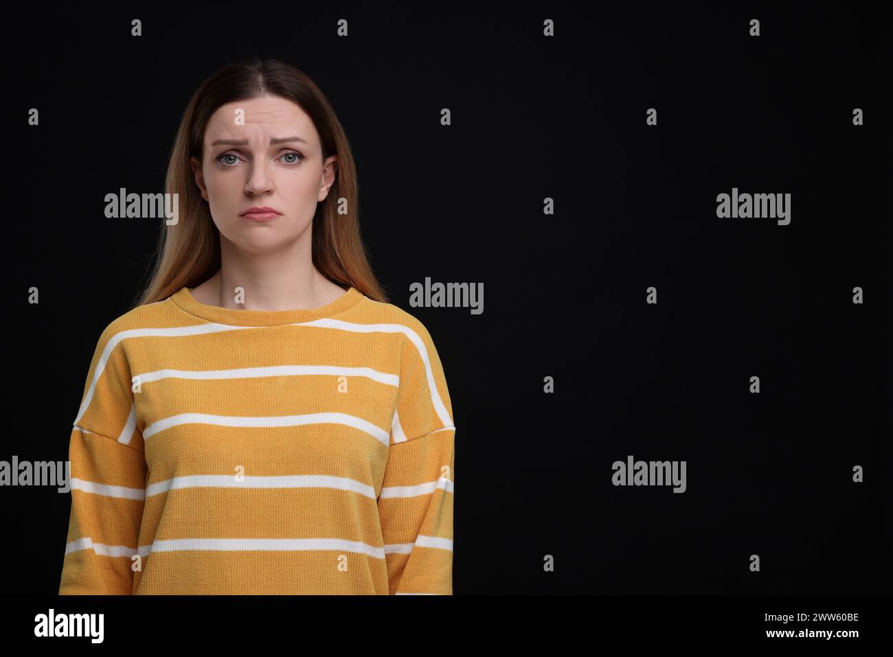 Portrait of sad woman on black background, space for text Stock Photo ...