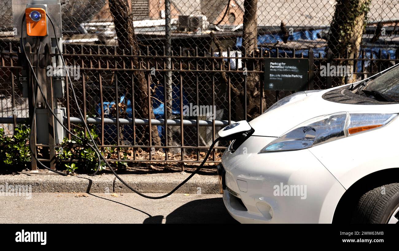 a-nissan-is-charging-at-a-charge-point-charge-station-the-street-on