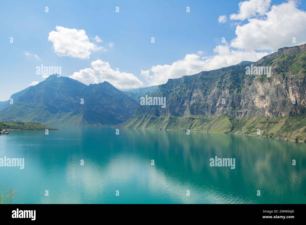 Tranquil Blue Lake Nestled Amidst Majestic Mountains Under a Clear Blue ...