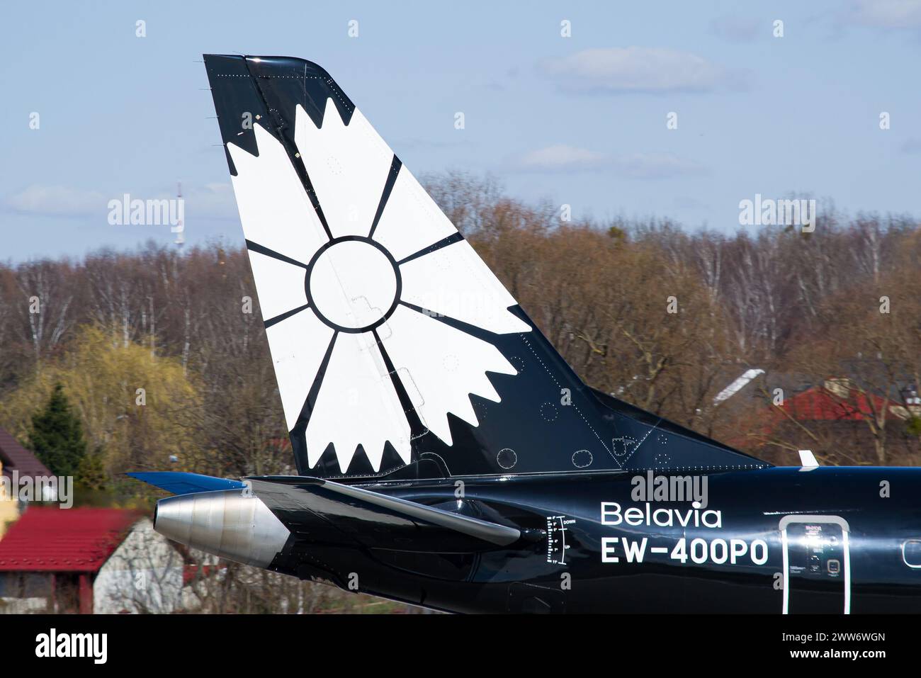 Vertical stabilizer close-up of a Belavia Embraer E195 in special 'World of Tanks' livery taxiing for takeoff at Lviv Airport Stock Photo