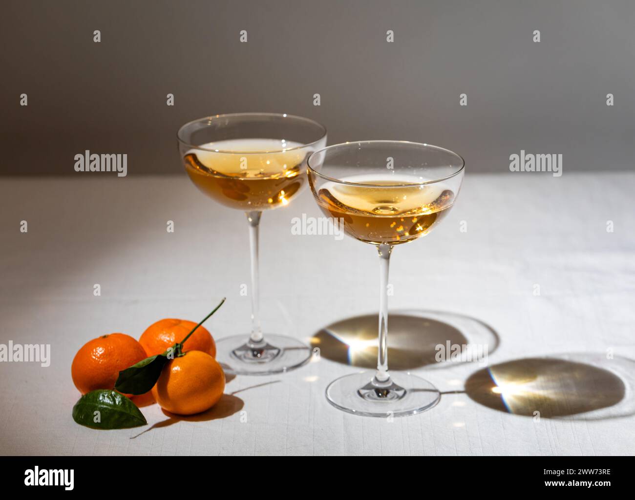 Vintage feel with two coupe glasses filled with orange wine next Stock Photo