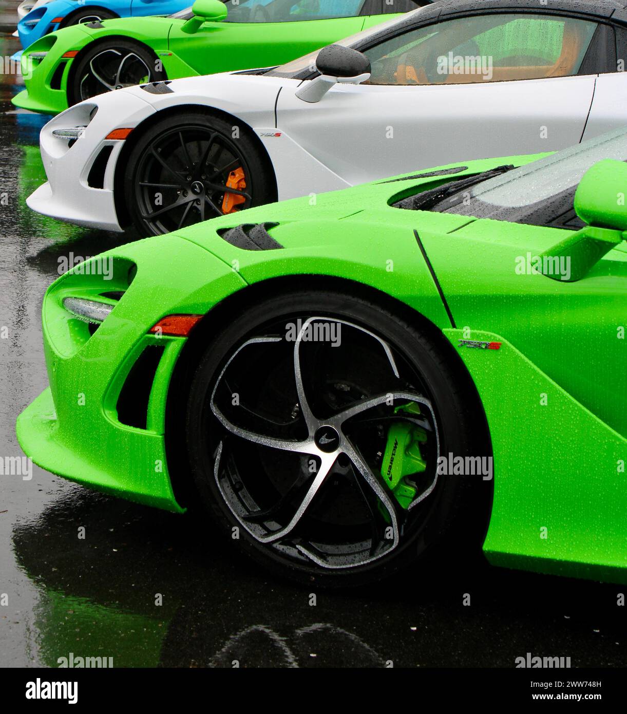 Multiple McLarens lined up in a parking lot on a rainy day Stock Photo