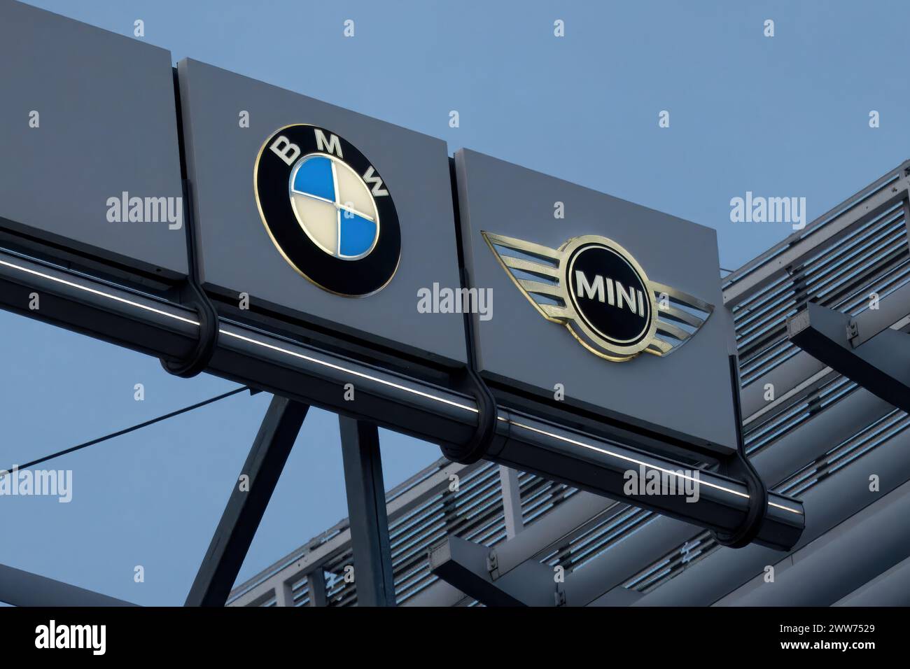 BMW and MINI logos on car dealership building - BMW is a German multinational car manufacturer. Stock Photo