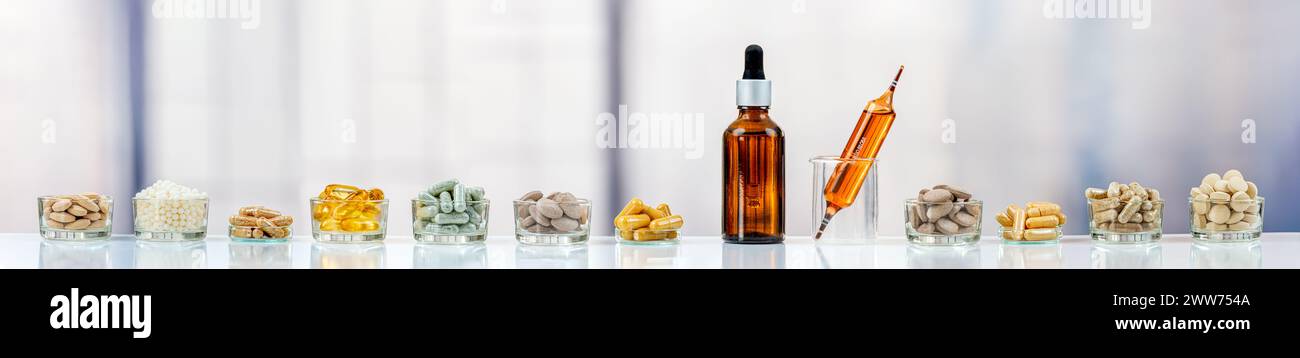 Panoramic of food supplements lined up in front of a bay window. Stock Photo