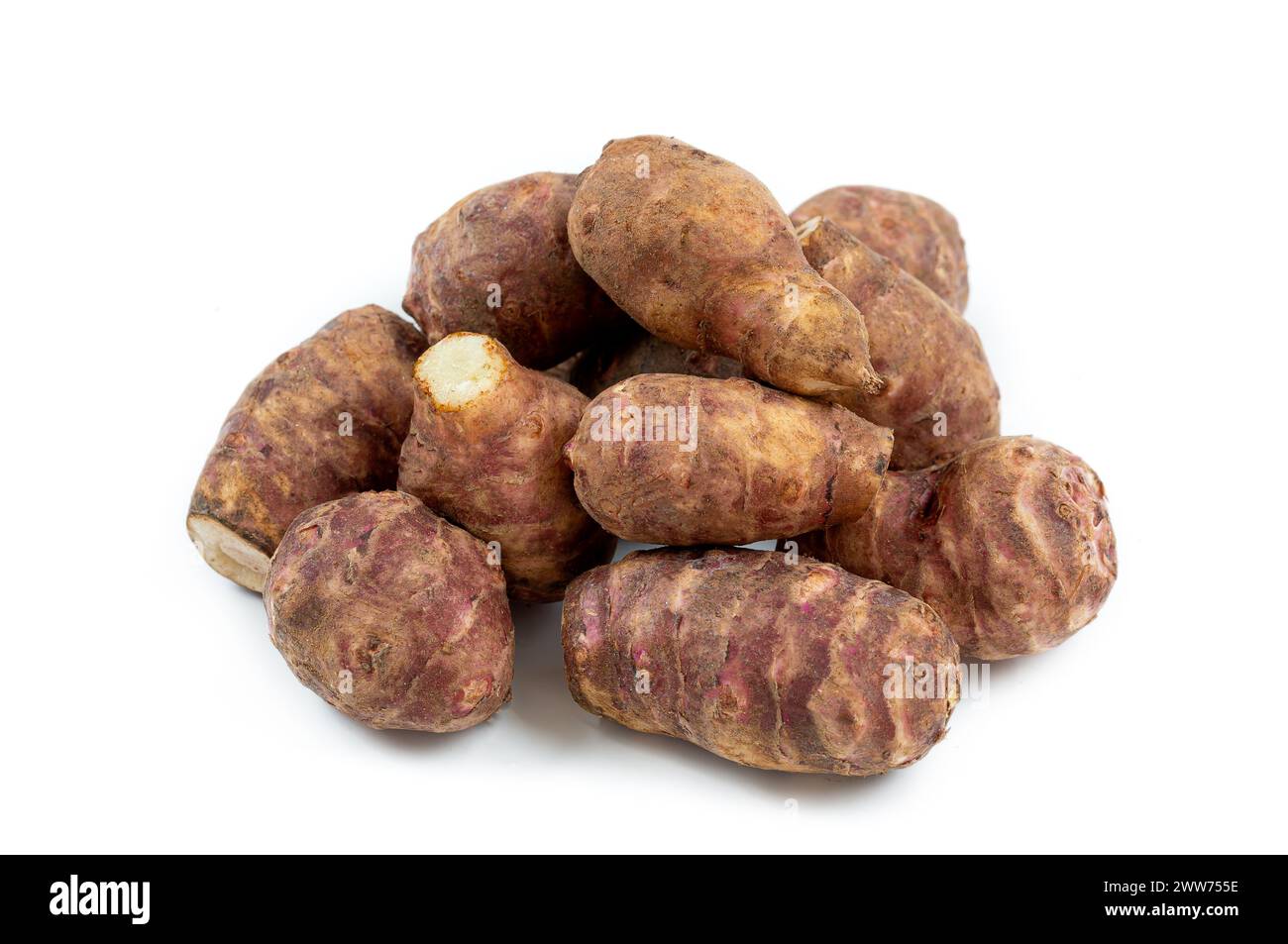 Jerusalem artichokes in heap top view on white background. Stock Photo