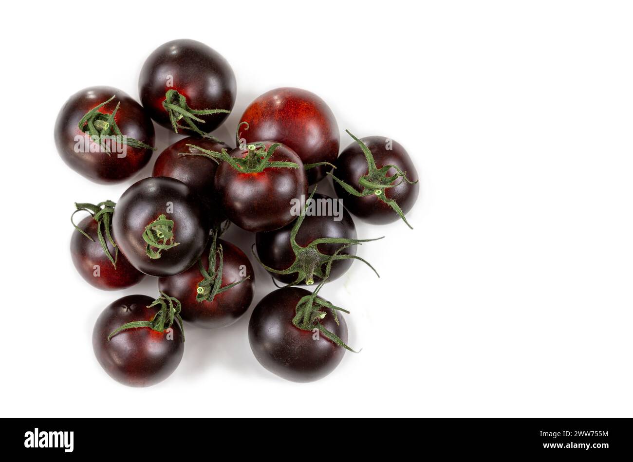 Handful of purple tomatoes top view on white background. Stock Photo