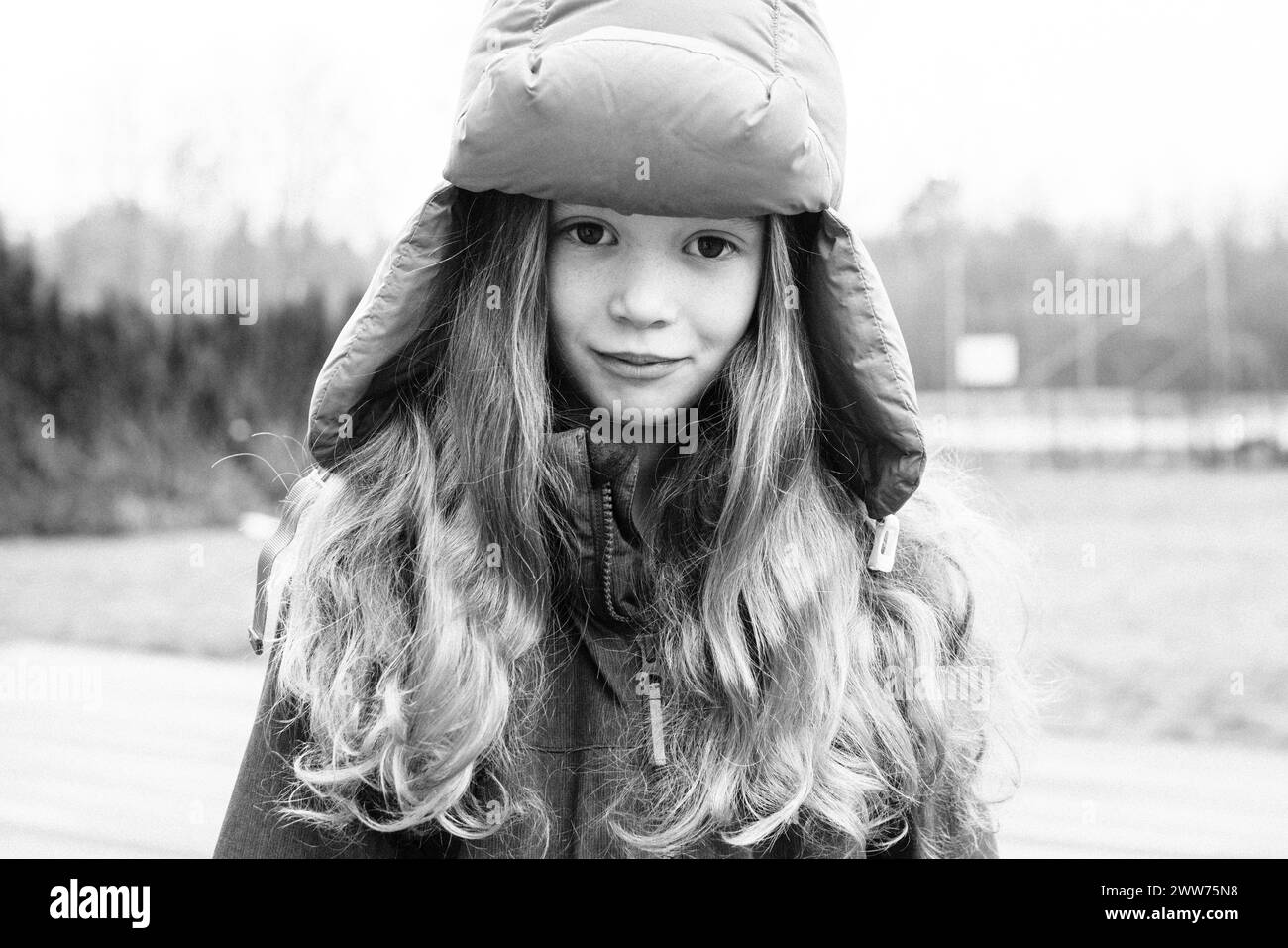 portrait of a girl aged 9 with long hair and a winter hat on Stock Photo