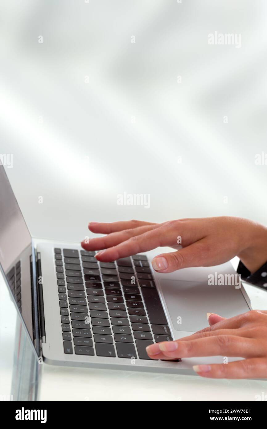 Hands typing on a computer keyboard- conceptual image. Stock Photo
