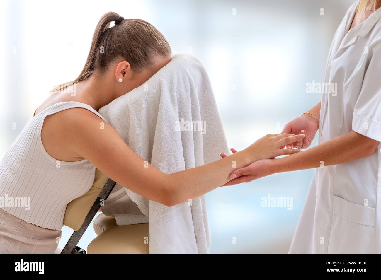Stretching the fingers during a seated massage. Stock Photo