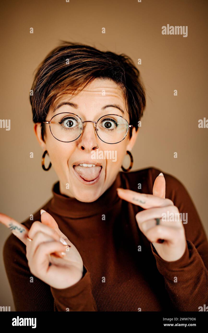 A short-haired woman with glasses posing for the camera Stock Photo