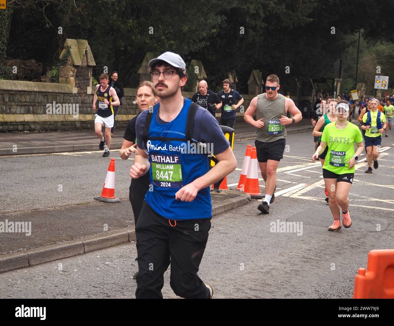 Runners taking part in the Bath Half Marathon 2024, including participant raising funds for Mind Bath Stock Photo