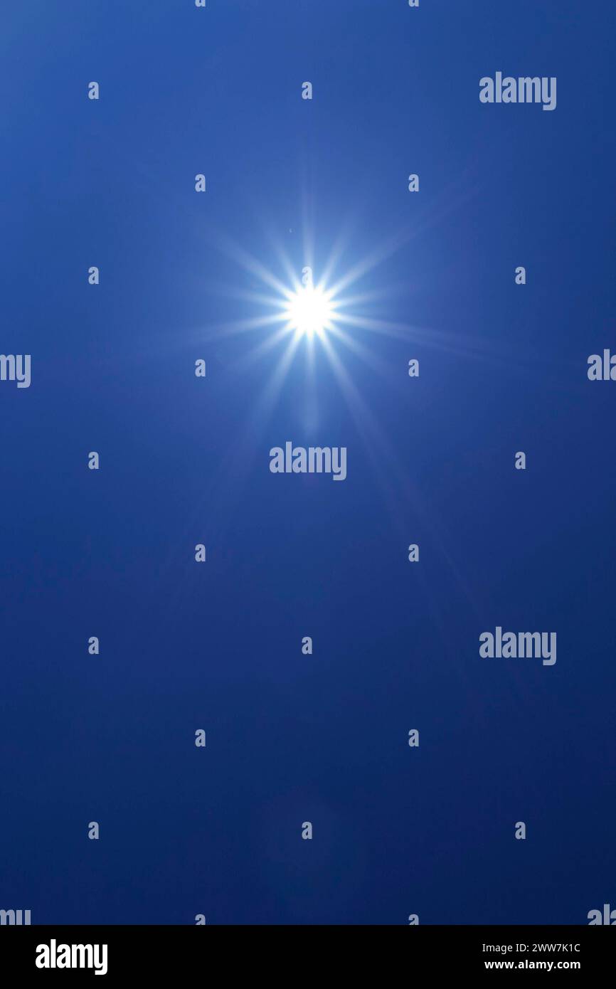 Sun in blue sky Stock Photo - Alamy