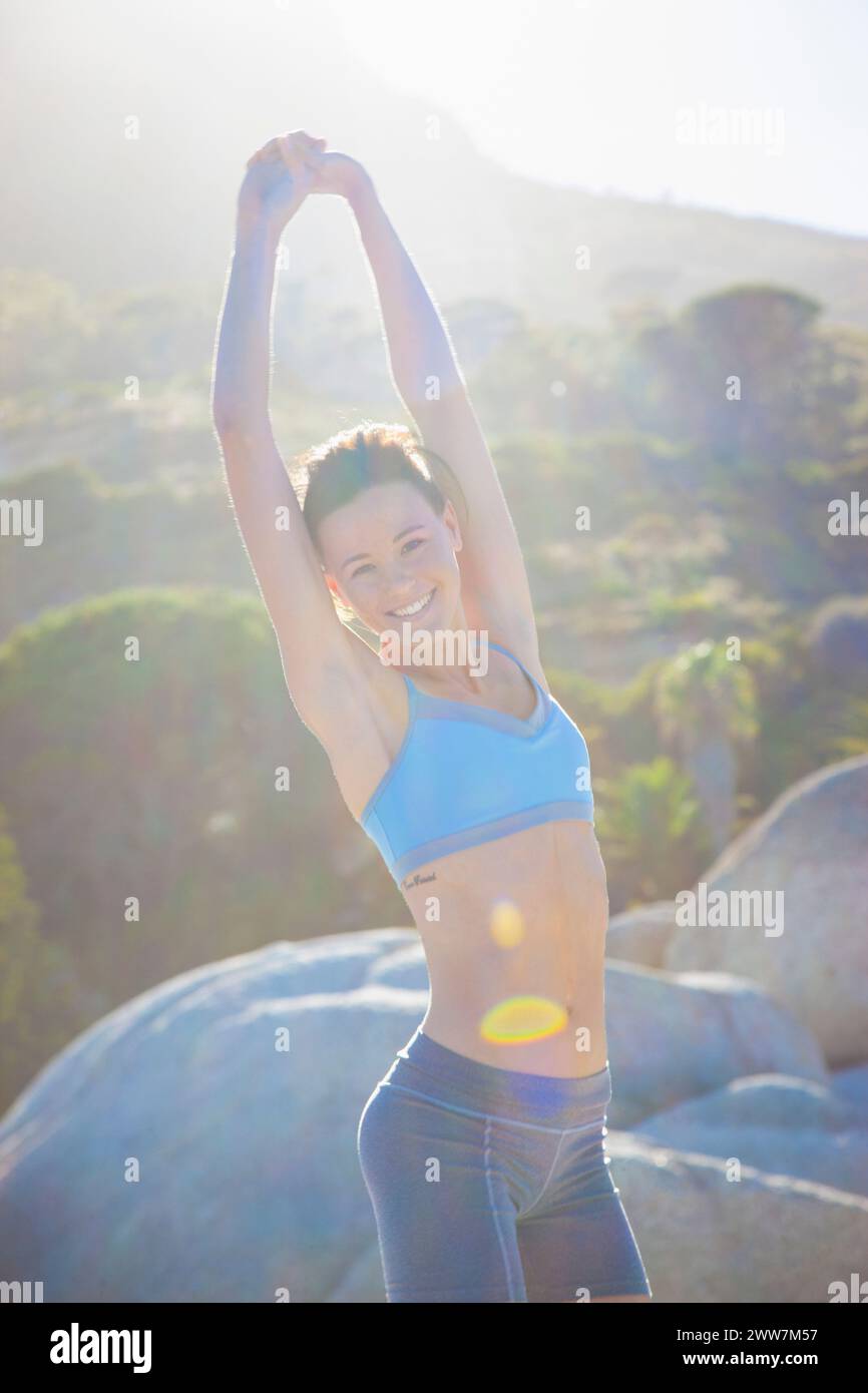 Woman Stretching Arms Outdoors Smiling Stock Photo