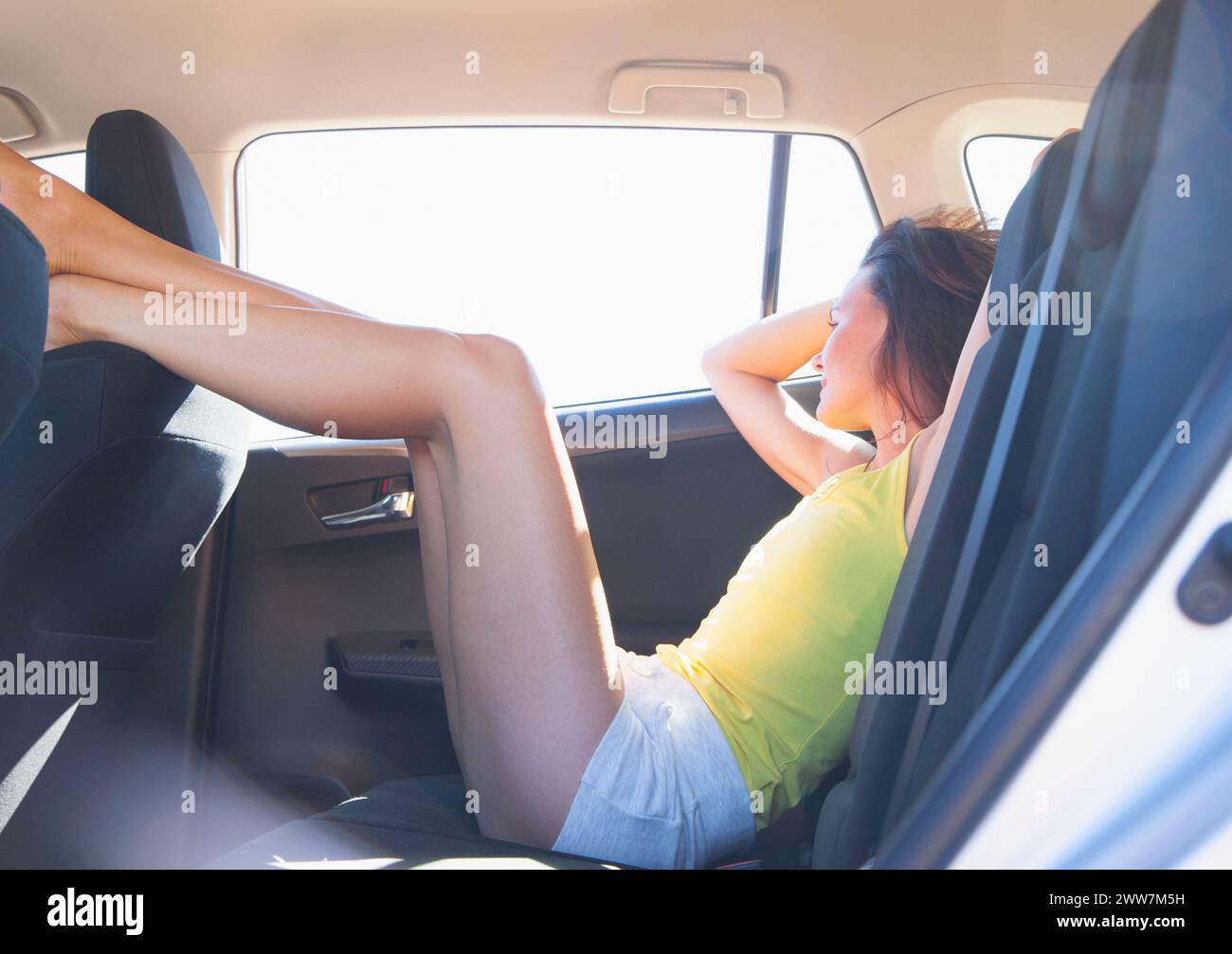Woman Reclining in Car Back Seat with Legs Raised Stock Photo Alamy
