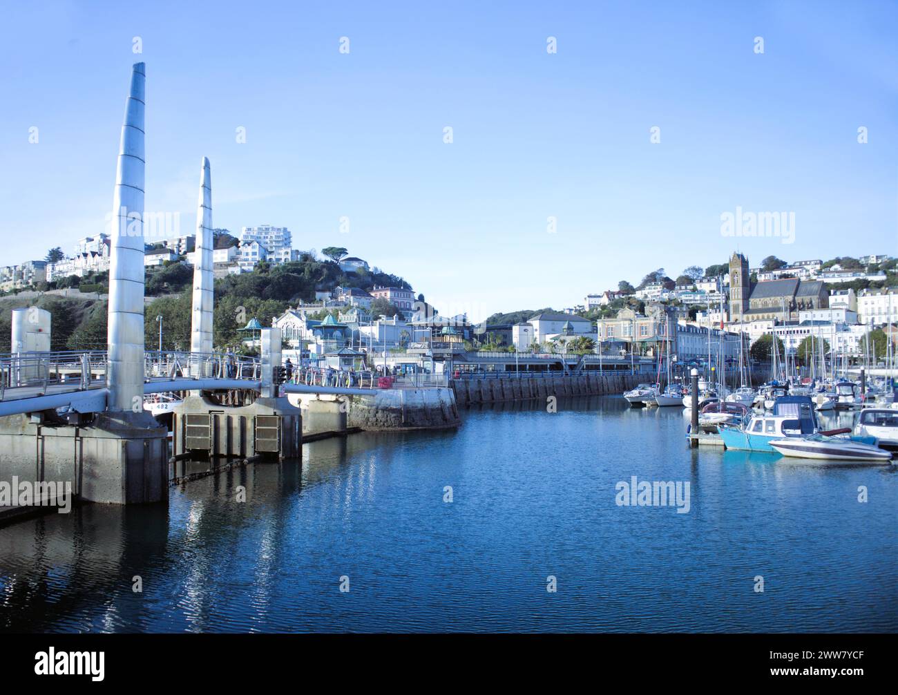 Torquay Harbour with the pedestrian bridge which holds a tidal cill between the outer and inner harbours. Torquay is in Torbay (The English Riviera) S Stock Photo