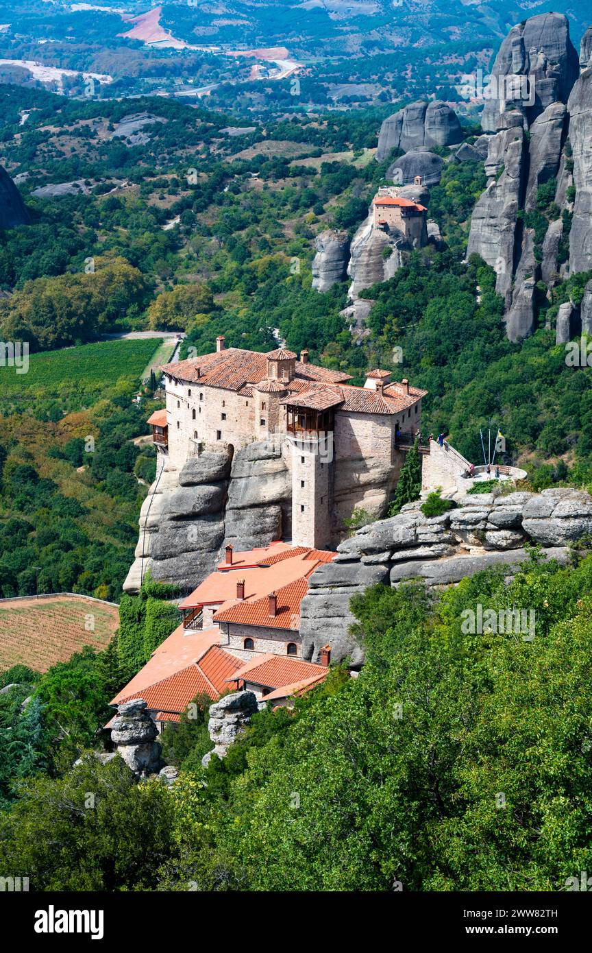 Monastery Meteora Greece. Stunning summer panoramic landscape. View at mountains and green forest against epic blue sky with clouds. UNESCO heritage l Stock Photo