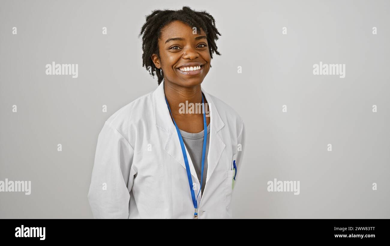 Smiling young african american woman with dreadlocks in a white lab ...