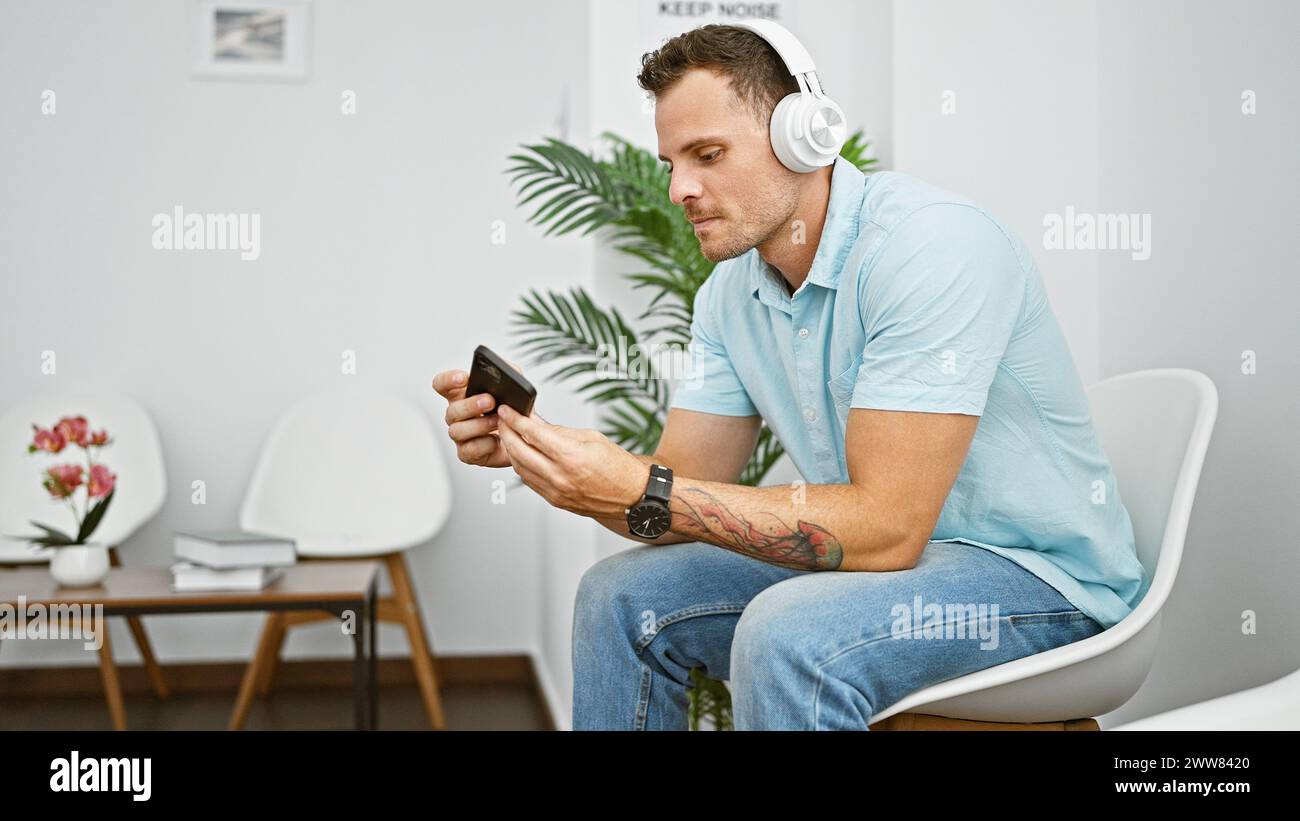 Man headphones uses smartphone hi-res stock photography and images - Alamy