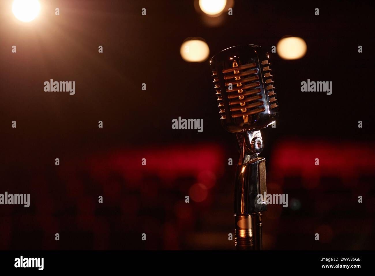 Still life of metal retro microphone on stage with spotlight copy space ...