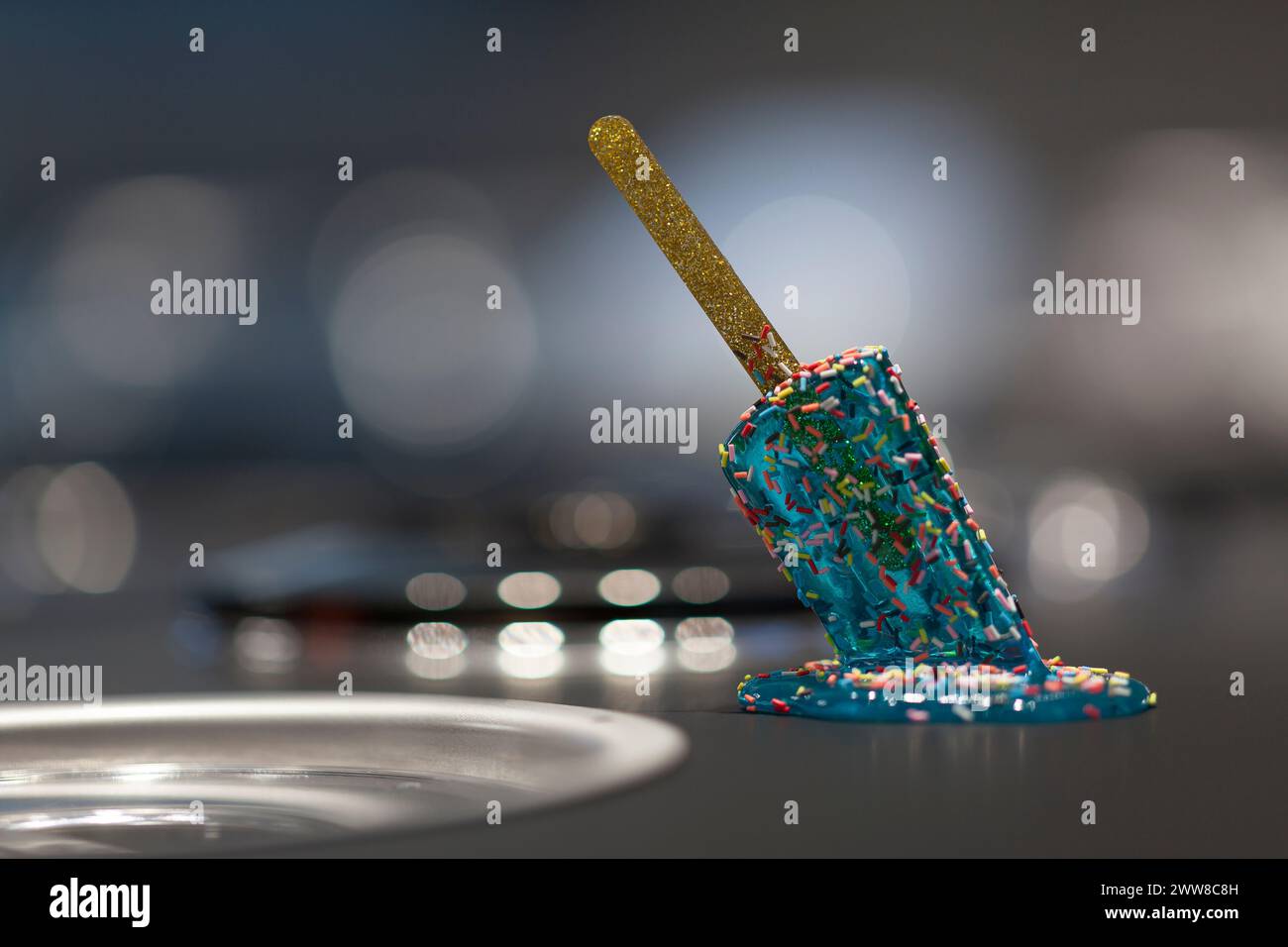 Close up on a melted popsicle on the iron table of a ice cream maker. Stock Photo