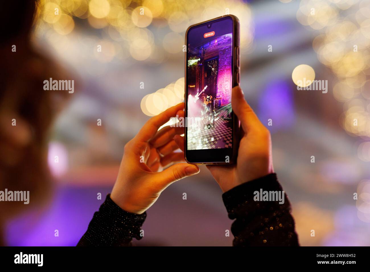 Silhouette of a hand with a mobile phone camera and enjoying the concert. Stock Photo