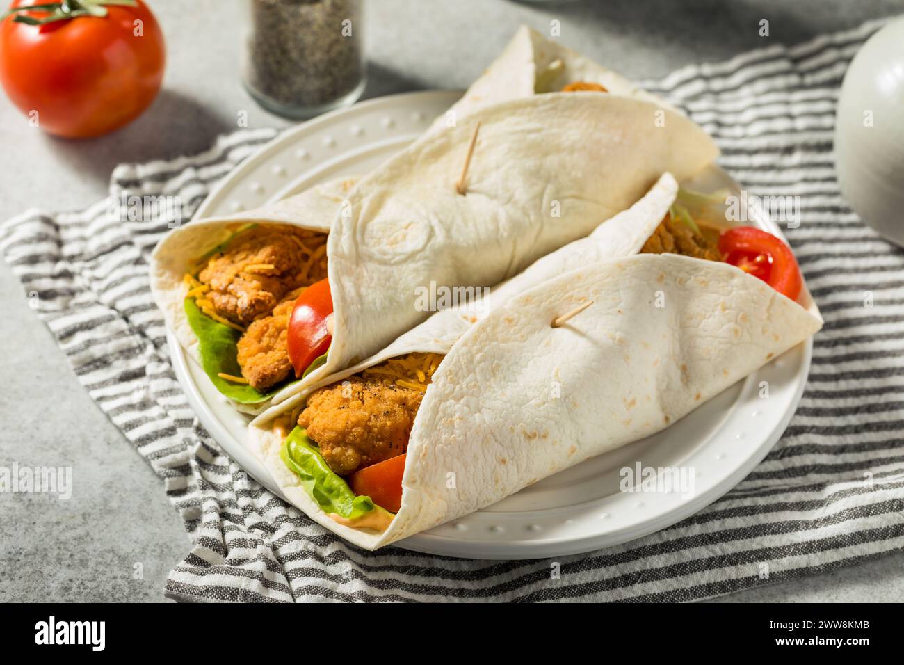 Healthy Homemade Fried Chicken Wrap with Tomato and Lettuce Stock Photo