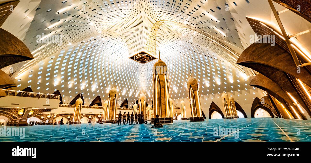 Bandung, Indonesia - 4th Nov 2023: Panoramic view of Al Jabbar Great Mosque interior, with few worshippers inside Stock Photo