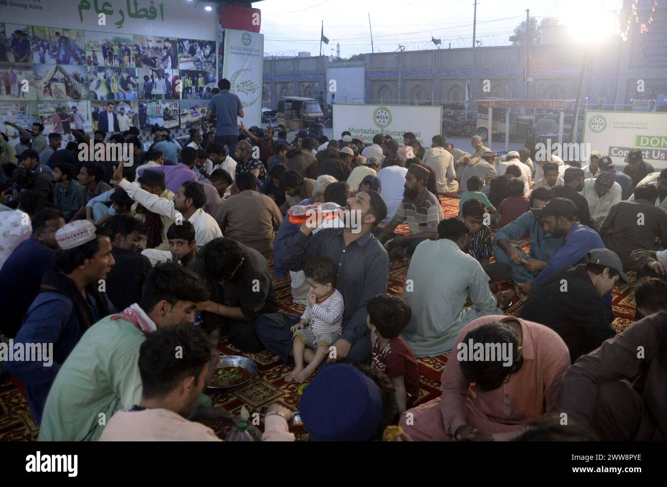 Faithful Muslims are breaking the fast (Iftar) under the supervision of ...
