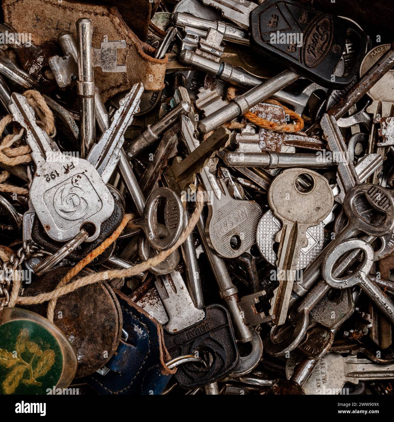 Close up of a tray of old car keys, house keys and antique keys. Shiny