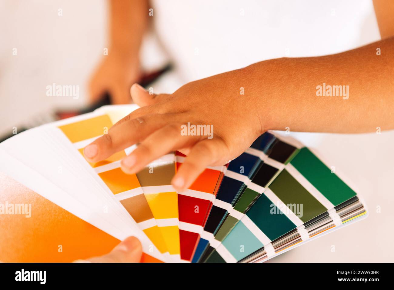 Close-up of a woman hand holding a palette of colors. A cute child ...